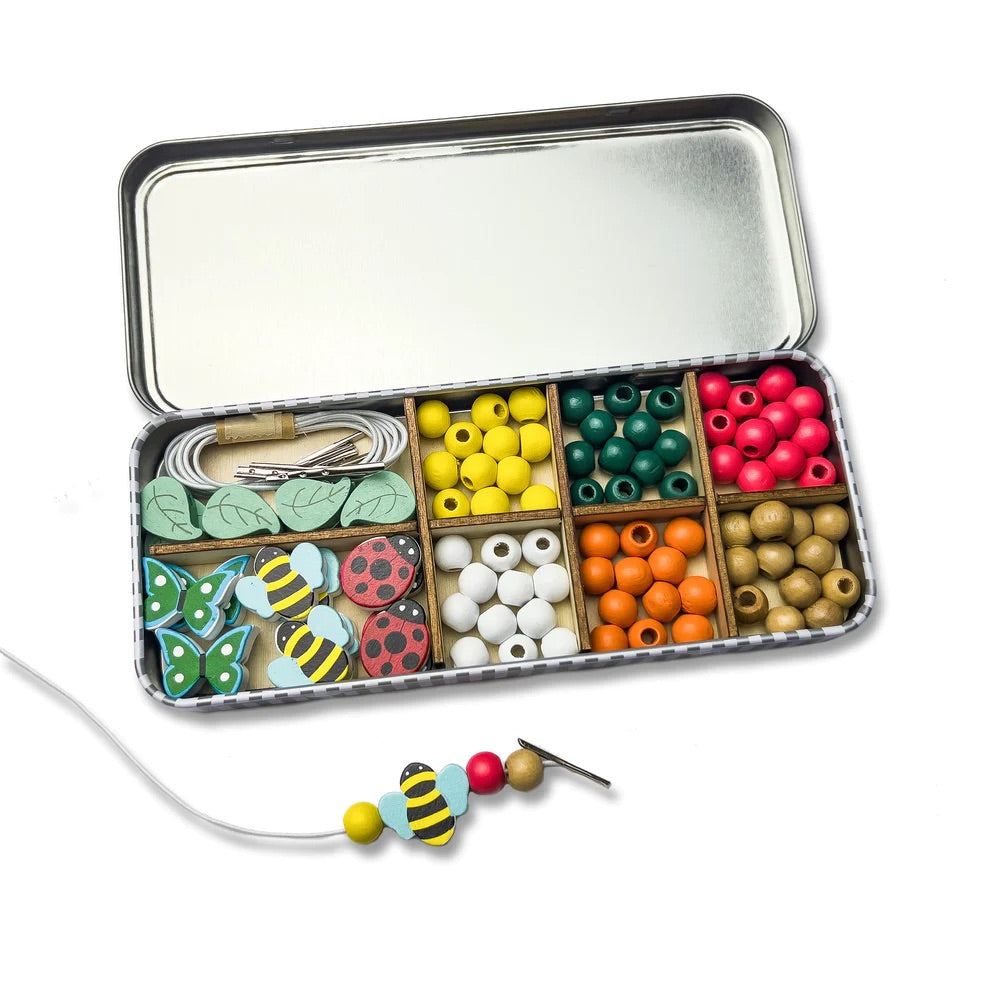 A wooden bracelet making set for children with enough beads to make 5 bracelets and a tin to keep them in