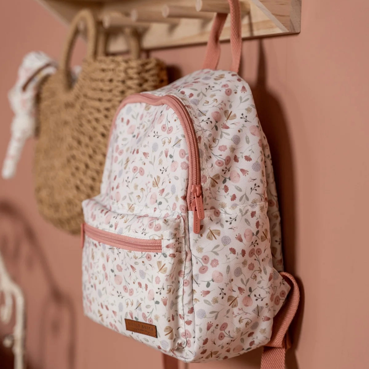 The Little Dutch Flowers and Butterflies children's backpack has a pretty pink floral print