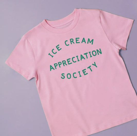 A strawberry pink children’s t shirt screen printed with ice cream appreciation society in green 