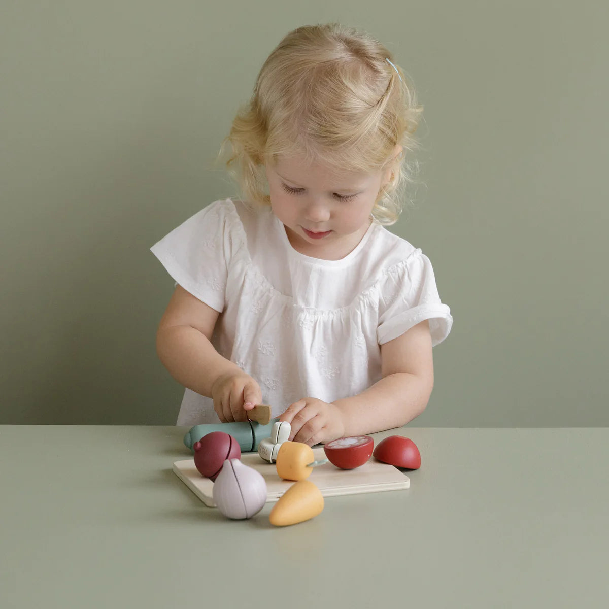 A child chopping the wooden Little Dutch cutting vegetables