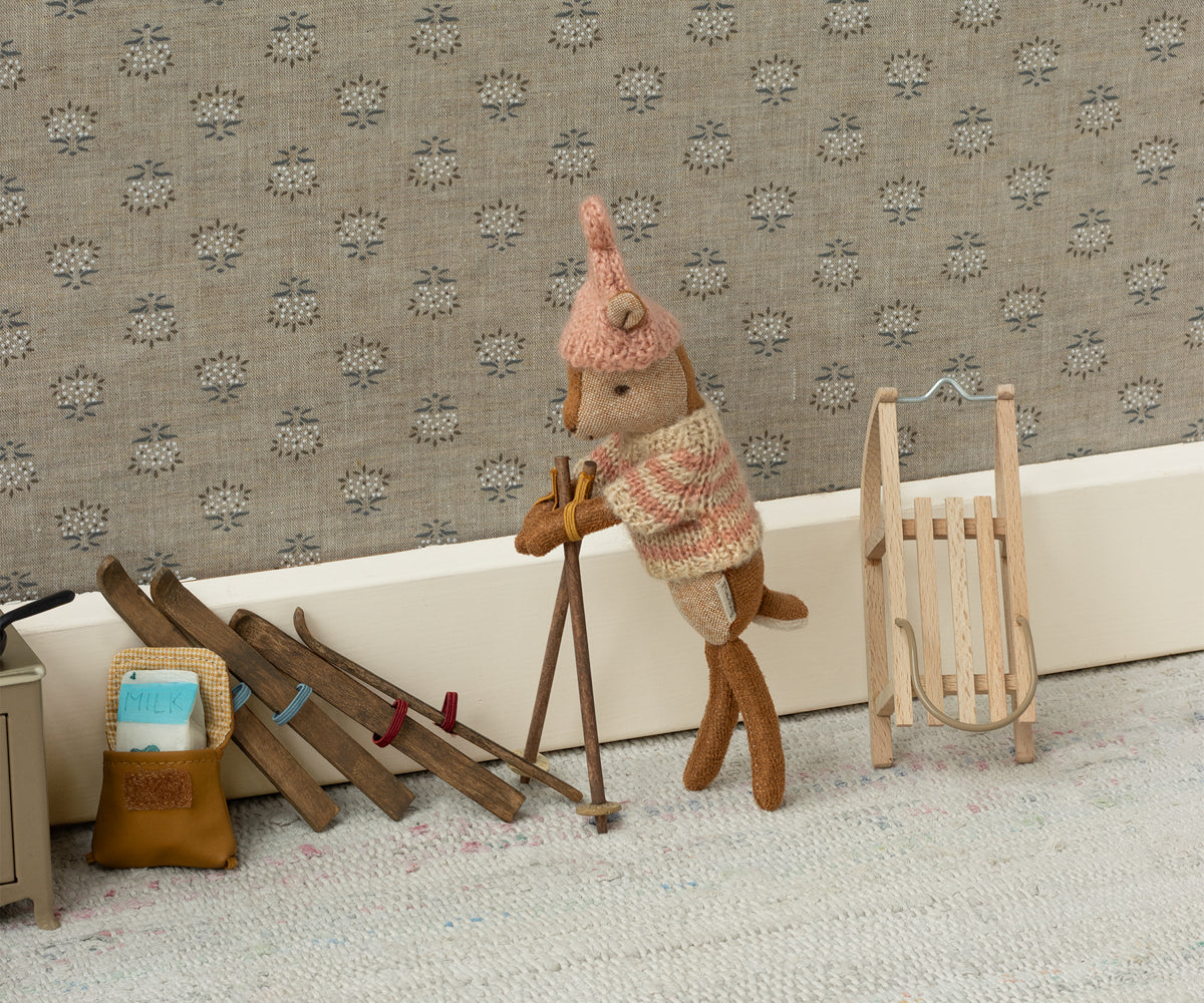 A Maileg little sister deer with a sled and skis ready for a winter adventure