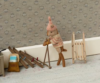 A Maileg little sister deer with a sled and skis ready for a winter adventure
