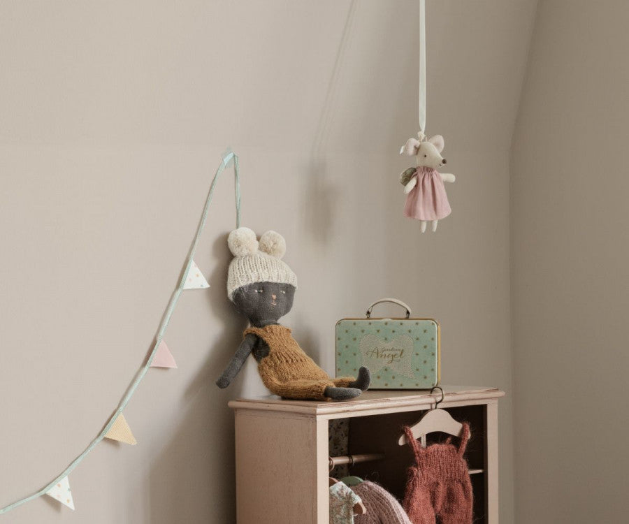Maileg Guardian angel little sister mouse displayed in a children's room with some ribbon tied to the little loop