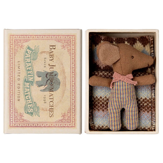 a little brown baby Maileg Mouse in a matchbox complete with bedding