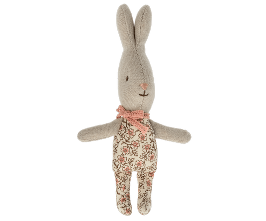 A mini sized maileg bunny in a pink floral outfit.