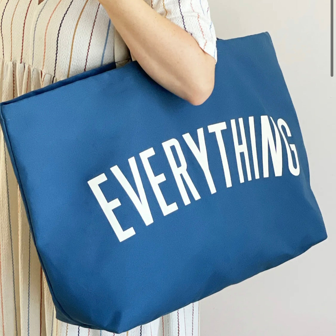 ocean blue tote bag screenprinted with the word everything in white